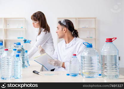 The two chemists working in the lab. Two chemists working in the lab