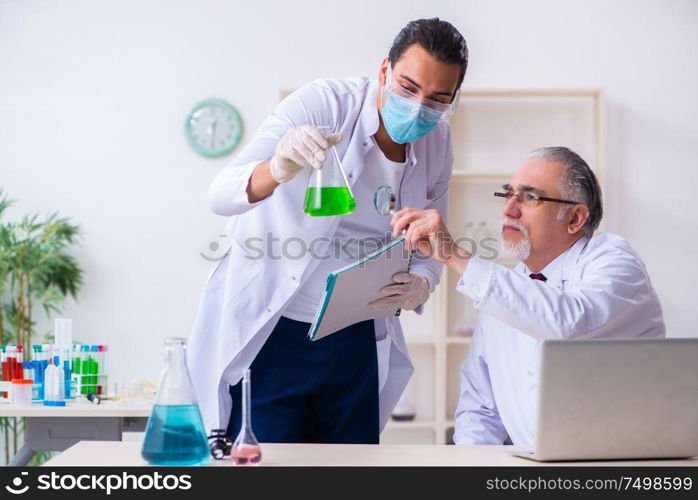 The two chemists working in the lab. Two chemists working in the lab