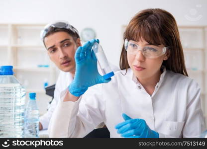 The two chemists working in the lab. Two chemists working in the lab