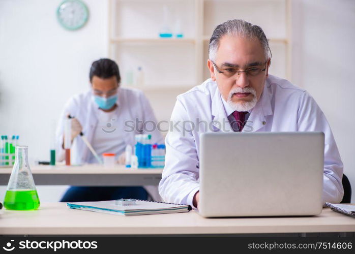 The two chemists working in the lab. Two chemists working in the lab