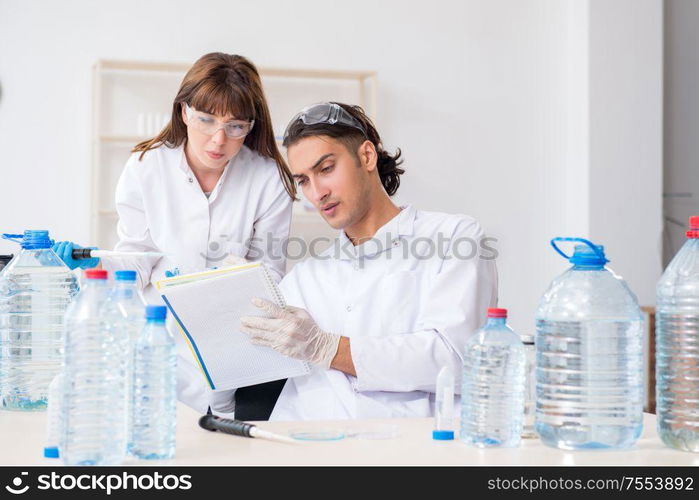 The two chemists working in the lab. Two chemists working in the lab