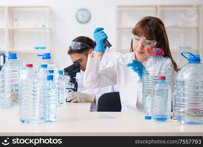 The two chemists working in the lab. Two chemists working in the lab