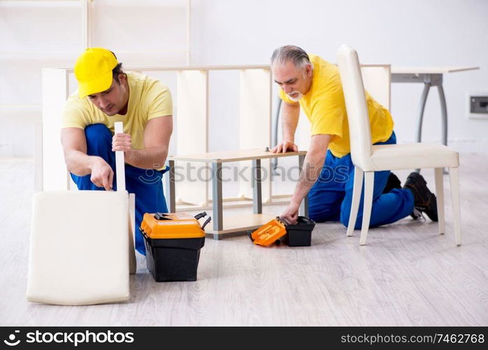 The two contractors carpenters working indoors . Two contractors carpenters working indoors 