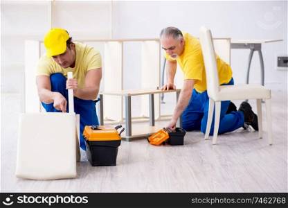 The two contractors carpenters working indoors . Two contractors carpenters working indoors 