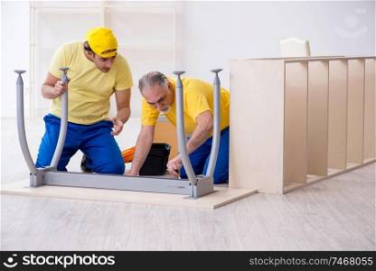 The two contractors carpenters working indoors . Two contractors carpenters working indoors 