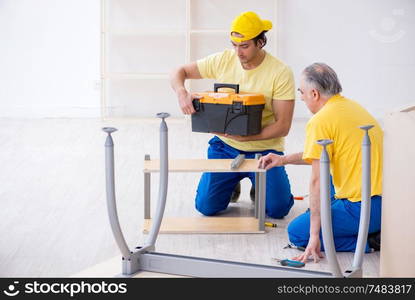 The two contractors carpenters working indoors. Two contractors carpenters working indoors