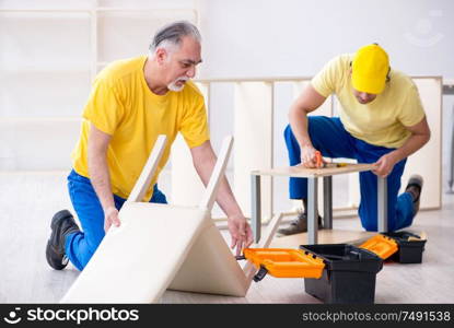 The two contractors carpenters working indoors. Two contractors carpenters working indoors