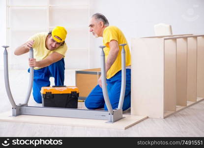 The two contractors carpenters working indoors. Two contractors carpenters working indoors