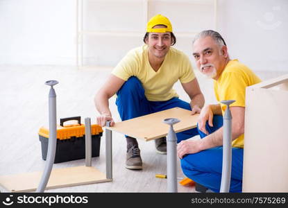 The two contractors carpenters working indoors. Two contractors carpenters working indoors