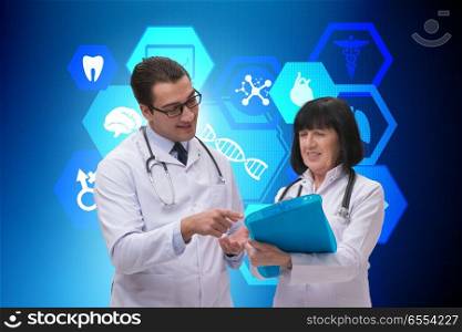 The two doctors discussing issues in telemedicine concept. Two doctors discussing issues in telemedicine concept. The two doctors discussing issues in telemedicine concept