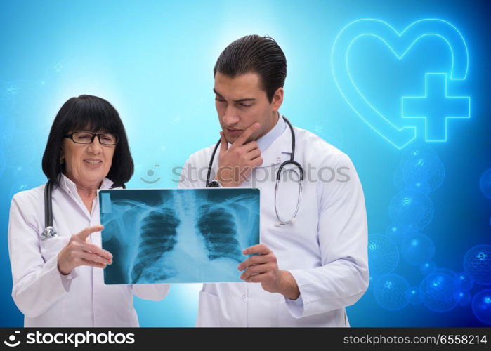 The two doctors discussing x-ray image in telemedicine concept. Two doctors discussing x-ray image in telemedicine concept. The two doctors discussing x-ray image in telemedicine concept