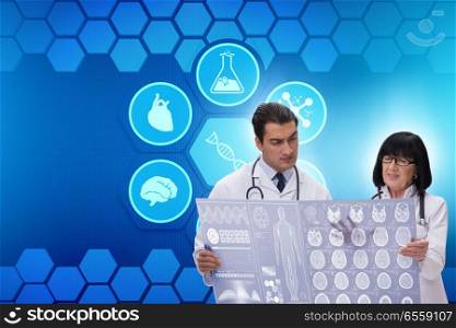 The two doctors discussing x-ray image in telemedicine concept. Two doctors discussing x-ray image in telemedicine concept. The two doctors discussing x-ray image in telemedicine concept