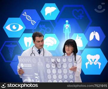 The two doctors discussing x-ray image in telemedicine concept. Two doctors discussing x-ray image in telemedicine concept