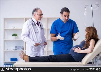 The two doctors examining young woman. Two doctors examining young woman