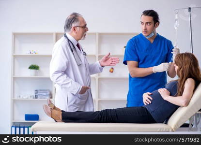 The two doctors examining young woman. Two doctors examining young woman