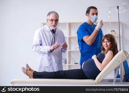 The two doctors examining young woman. Two doctors examining young woman