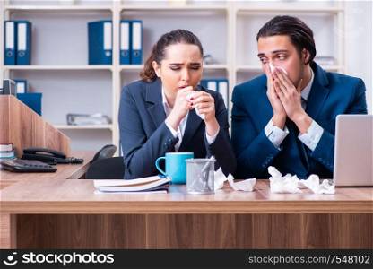 The two employees suffering at workplace. Two employees suffering at workplace