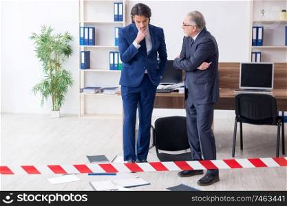 The two experts criminologists working in the office . Two experts criminologists working in the office 