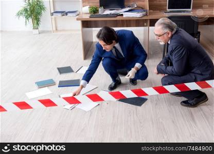 The two experts criminologists working in the office . Two experts criminologists working in the office