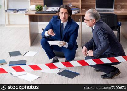 The two experts criminologists working in the office. Two experts criminologists working in the office