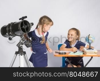 The two girls looked at each other in the classroom Astronomy