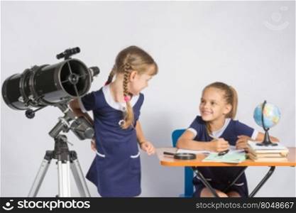 The two girls looked at each other in the classroom Astronomy