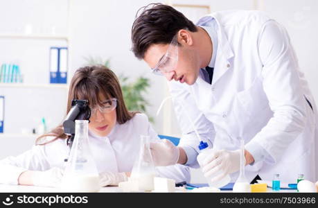 The two lab doctor testing food products. Two lab doctor testing food products