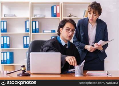 The two lawyers working in the office. Two lawyers working in the office