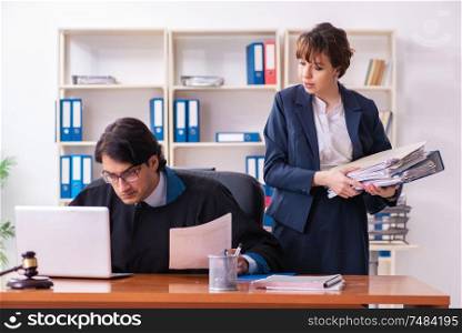 The two lawyers working in the office. Two lawyers working in the office