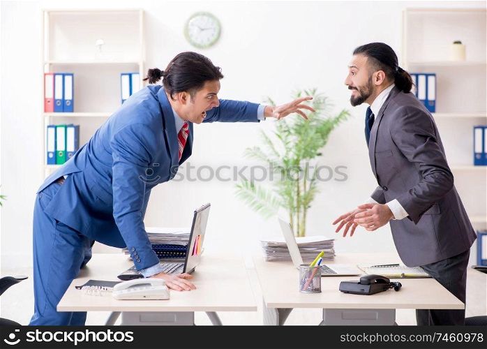 The two male colleagues in the office . Two male colleagues in the office 