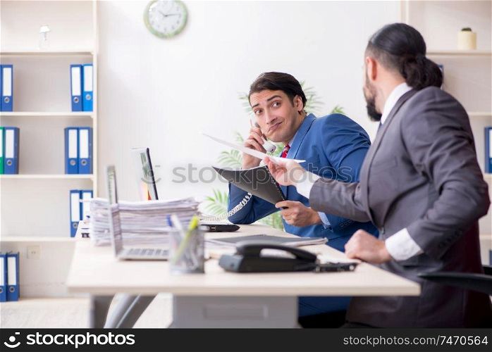 The two male colleagues in the office . Two male colleagues in the office 
