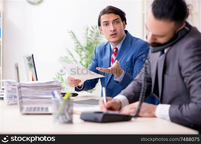The two male colleagues in the office. Two male colleagues in the office