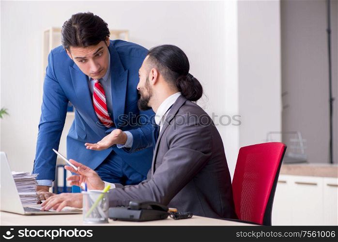 The two male colleagues in the office. Two male colleagues in the office