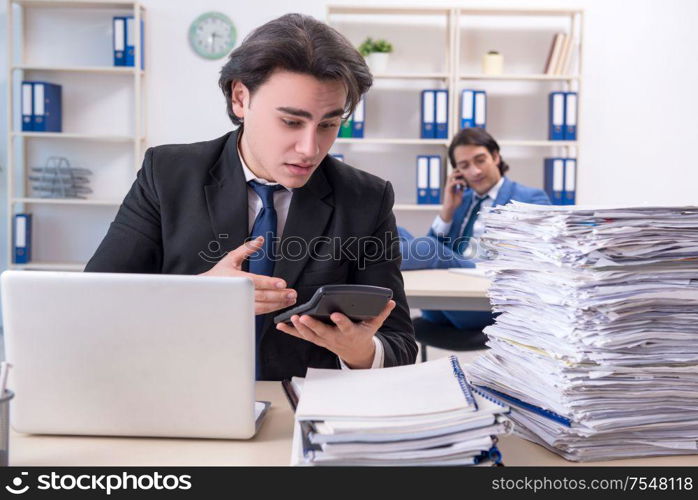 The two male colleagues unhappy with excessive work. Two male colleagues unhappy with excessive work