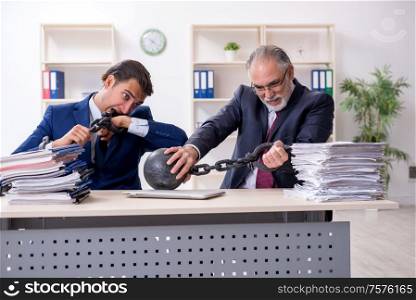 The two male employees unhappy with excessive work. Two male employees unhappy with excessive work