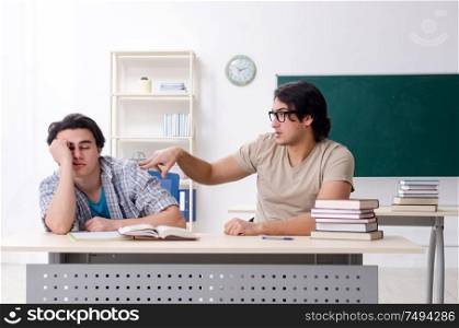 The two male students in the classroom. Two male students in the classroom