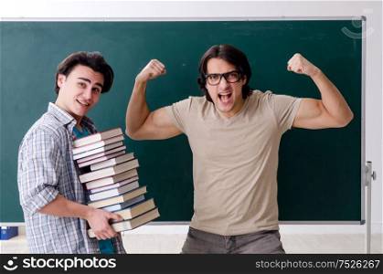 The two male students in the classroom. Two male students in the classroom
