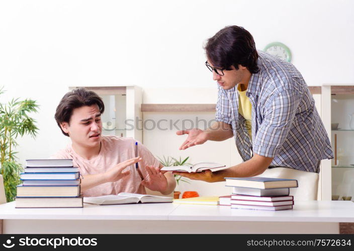 The two male students preparing for exams at home. Two male students preparing for exams at home