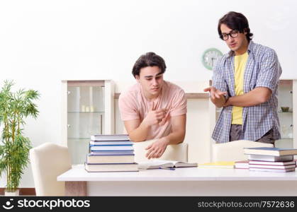 The two male students preparing for exams at home. Two male students preparing for exams at home