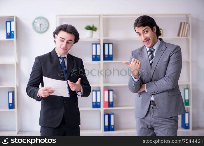 The two young businessmen meeting in the office. Two young businessmen meeting in the office