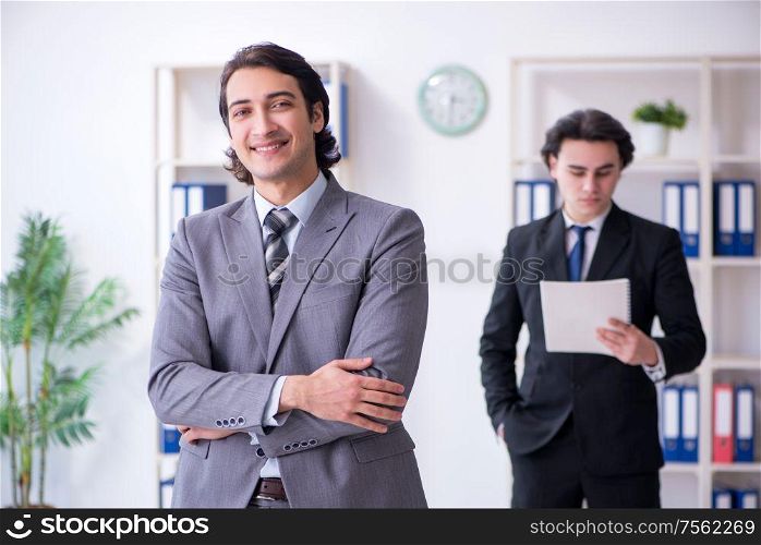 The two young businessmen meeting in the office. Two young businessmen meeting in the office