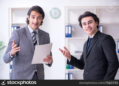 The two young businessmen meeting in the office. Two young businessmen meeting in the office