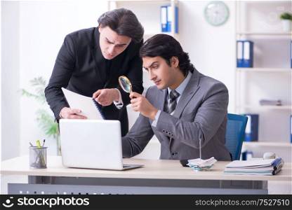 The two young employees working in the office. Two young employees working in the office