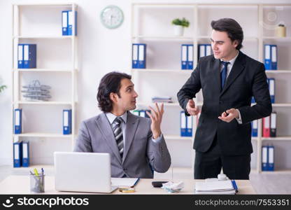 The two young employees working in the office. Two young employees working in the office