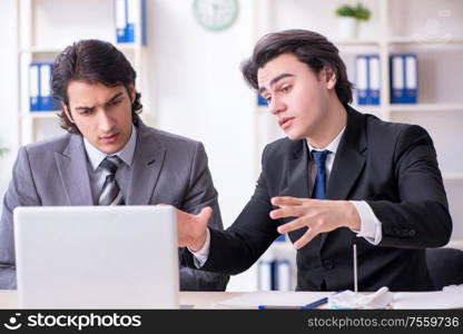 The two young employees working in the office. Two young employees working in the office