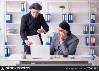 The two young employees working in the office. Two young employees working in the office