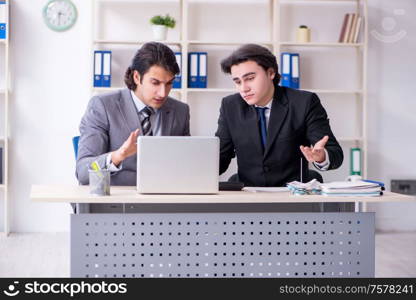 The two young employees working in the office. Two young employees working in the office