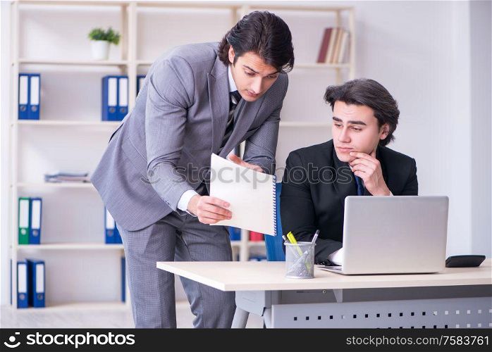 The two young employees working in the office. Two young employees working in the office