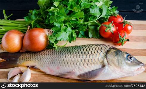 The uncooked fish on cutting board in meal preparation concept. Uncooked fish on cutting board in meal preparation concept