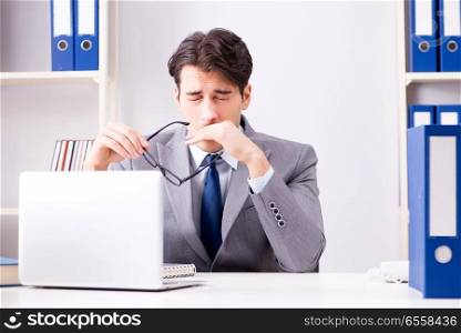 The unhappy businessman working in office. Unhappy businessman working in office